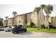 Condo building with palm trees and parking at 596 Orange Dr # 151, Altamonte Springs, FL 32701