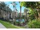 Inviting community pool surrounded by tropical foliage at 596 Orange Dr # 151, Altamonte Springs, FL 32701