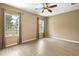 Bright bedroom with wood-look flooring and large windows at 745 Andrew St, Eustis, FL 32726