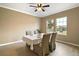 Bright dining area with striped chairs and large windows at 745 Andrew St, Eustis, FL 32726