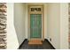 Inviting entryway with a green door and welcome mat at 745 Andrew St, Eustis, FL 32726