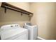 Laundry room with Whirlpool washer and dryer and shelving at 745 Andrew St, Eustis, FL 32726