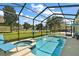 Screened pool and spa with view of neighborhood at 745 Andrew St, Eustis, FL 32726