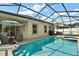 Inviting pool and spa with screened enclosure at 745 Andrew St, Eustis, FL 32726