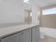 Modern bathroom with gray vanity and a shower/tub combo at 9118 Waverly Walk Dr, Orlando, FL 32817