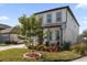 Two-story house with gray accents and a tree in the front yard at 9118 Waverly Walk Dr, Orlando, FL 32817