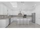 Modern kitchen with white cabinets, island, and stainless steel appliances at 9118 Waverly Walk Dr, Orlando, FL 32817