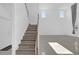 Modern staircase with wooden steps and white railing at 9118 Waverly Walk Dr, Orlando, FL 32817