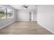 Bright bedroom with large window, wood-look flooring, and ceiling fan at 10140 Bridlewood Ave, Orlando, FL 32825