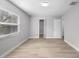 Bright bedroom with light gray walls, wood-look floors and a closet at 10140 Bridlewood Ave, Orlando, FL 32825