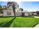 Single story home, white with stone accents, palm tree at 10140 Bridlewood Ave, Orlando, FL 32825