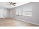 Living room featuring light gray walls, wood-look floors, and a view of the entryway at 10140 Bridlewood Ave, Orlando, FL 32825