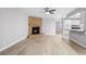 Living room featuring a brick fireplace and wood-look floors at 10140 Bridlewood Ave, Orlando, FL 32825