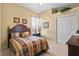 Well-lit bedroom with a double bed and window view at 107 Alexandra Woods Dr, Debary, FL 32713