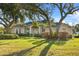 House exterior showcasing a large yard with lush landscaping at 107 Alexandra Woods Dr, Debary, FL 32713