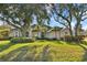 House exterior with lush landscaping and large trees at 107 Alexandra Woods Dr, Debary, FL 32713