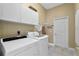 Laundry room with washer, dryer, and storage cabinets at 107 Alexandra Woods Dr, Debary, FL 32713