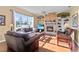 Living room with brick fireplace, hardwood floors, and built-in shelving at 107 Alexandra Woods Dr, Debary, FL 32713