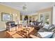 Sunlit living room features leather furniture and hardwood floors at 107 Alexandra Woods Dr, Debary, FL 32713