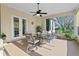 Relaxing screened patio with seating area, ceiling fan, and view of the backyard at 107 Alexandra Woods Dr, Debary, FL 32713