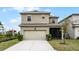 Two-story house with attached garage and landscaping at 11833 Founders St, Orlando, FL 32832