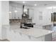 Modern kitchen with white cabinets, quartz countertops, and breakfast bar at 11833 Founders St, Orlando, FL 32832