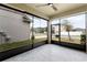 Spacious screened porch with tiled floor and ceiling fan at 11833 Founders St, Orlando, FL 32832