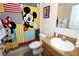 bathroom with Mickey Mouse shower curtain and vanity at 142 Sandy Point Way, Clermont, FL 34714