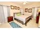 Comfortable bedroom with a king-size bed and wooden dresser at 142 Sandy Point Way, Clermont, FL 34714