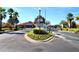 Gated community entrance with landscaping and guard house at 142 Sandy Point Way, Clermont, FL 34714