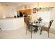 Kitchen dining area with glass-top table and four chairs at 142 Sandy Point Way, Clermont, FL 34714