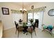 Bright dining area with table, four chairs, and access to patio at 142 Sandy Point Way, Clermont, FL 34714