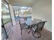 Screened patio with table and chairs overlooking the pool at 142 Sandy Point Way, Clermont, FL 34714