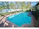 Inviting, refreshing pool with safety fence at 142 Sandy Point Way, Clermont, FL 34714