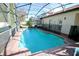 Inviting screened pool with brick patio and safety fence at 142 Sandy Point Way, Clermont, FL 34714