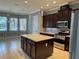 Kitchen featuring granite countertops, stainless steel appliances and an island at 15041 Gaulberry Run, Winter Garden, FL 34787