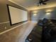 Home theater with large screen, comfortable seating, and dimmable lighting at 15041 Gaulberry Run, Winter Garden, FL 34787