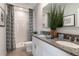 Bathroom with double vanity, shower, and patterned curtain at 1521 Isleta Loop, Kissimmee, FL 34741