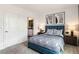 Cozy bedroom with a blue upholstered bed and en-suite bathroom access at 1521 Isleta Loop, Kissimmee, FL 34741