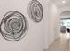 Hallway with two modern circular wall art pieces at 1521 Isleta Loop, Kissimmee, FL 34741