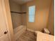 Bathroom with a bathtub, toilet and window at 15306 Southern Martin St, Winter Garden, FL 34787