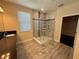 Large walk-in shower with tile surround and built-in shelving at 15306 Southern Martin St, Winter Garden, FL 34787