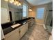 Double vanity bathroom with granite countertop and glass shower at 15306 Southern Martin St, Winter Garden, FL 34787