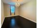 Bright bedroom with dark hardwood floors and chandelier at 15306 Southern Martin St, Winter Garden, FL 34787