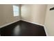 Simple bedroom with dark hardwood floors and window at 15306 Southern Martin St, Winter Garden, FL 34787