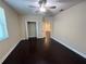 Bedroom with ceiling fan, dark hardwood floors and closet at 15306 Southern Martin St, Winter Garden, FL 34787