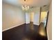 Spacious bedroom with dark hardwood floors, chandelier and private closet at 15306 Southern Martin St, Winter Garden, FL 34787