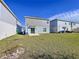 View of the home's backyard with grass and some trees at 1534 Marksman Rd, Eagle Lake, FL 33839