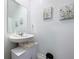 Clean bathroom with pedestal sink, mirror, and wall art at 1534 Marksman Rd, Eagle Lake, FL 33839