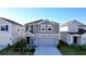 Two-story house with gray siding and a two-car garage at 1534 Marksman Rd, Eagle Lake, FL 33839